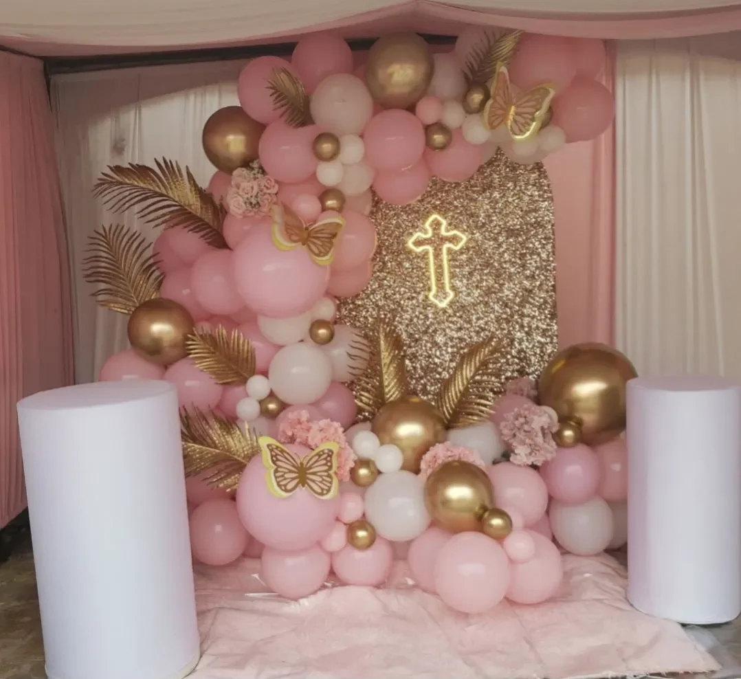 Pink, white, and yellow Christian themed balloon backdrop with cross