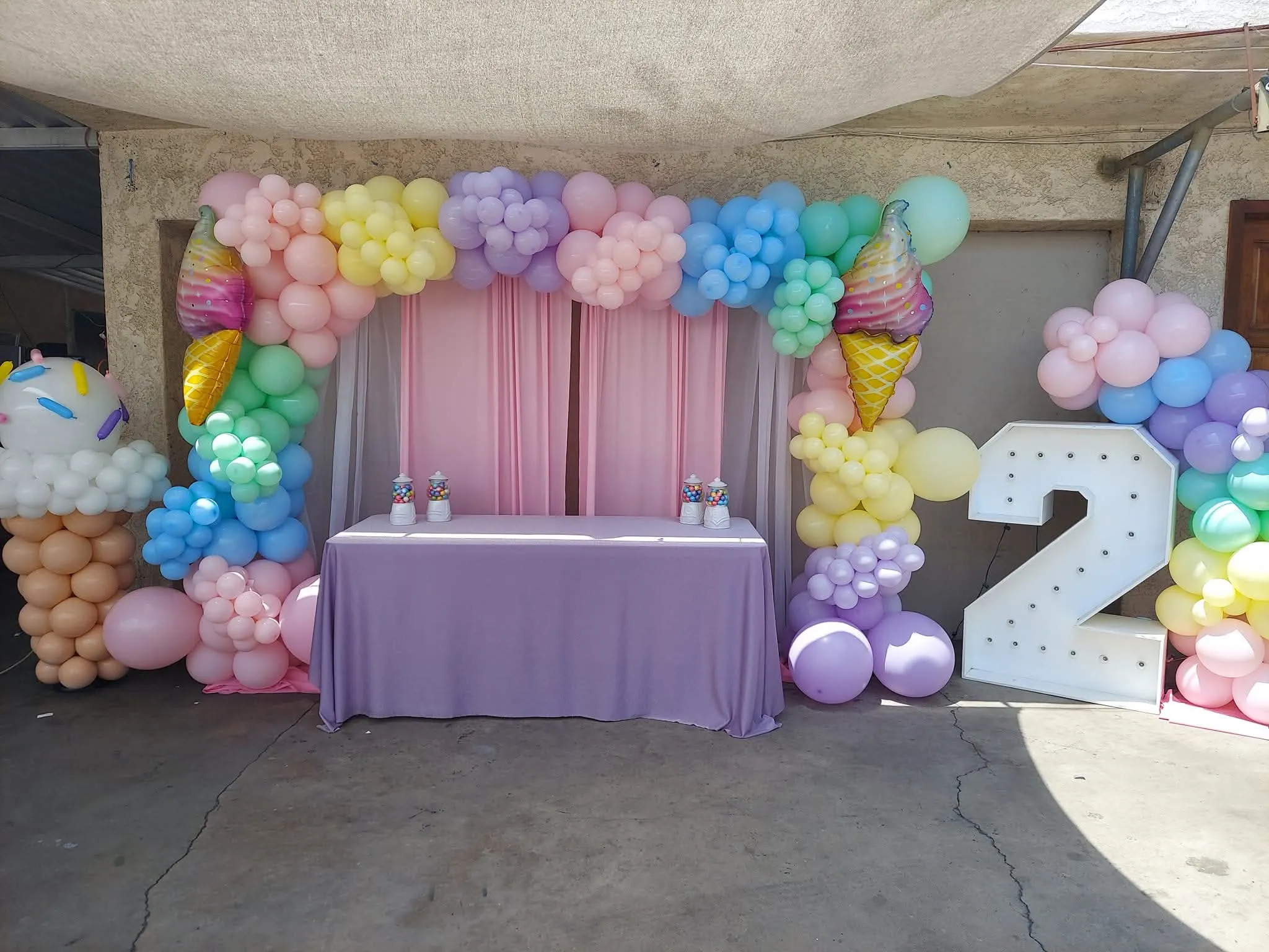 2nd birthday ice cream themed balloon backdrop with table