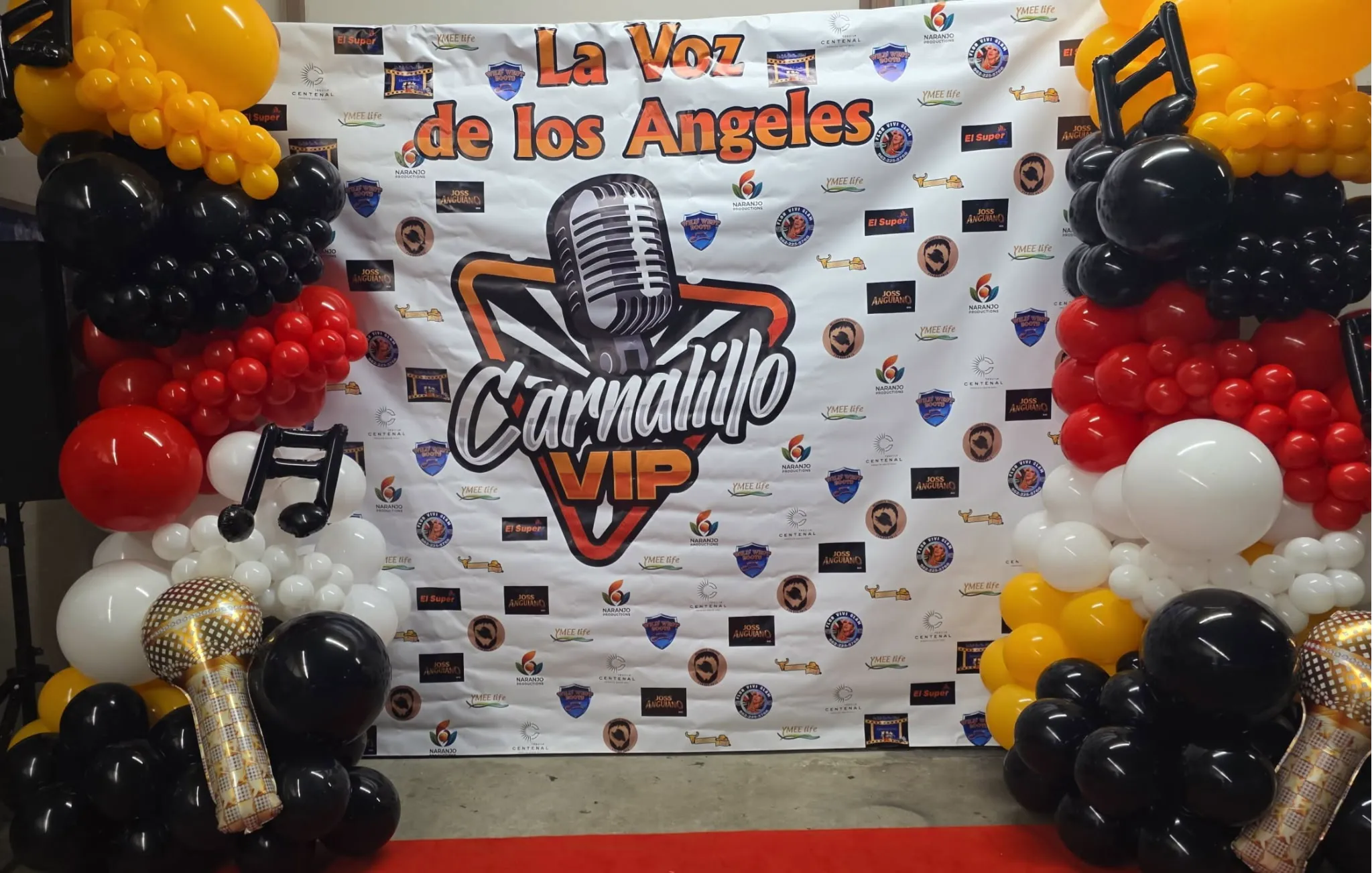 White, red, black, and yellow balloon backdrop for radio show