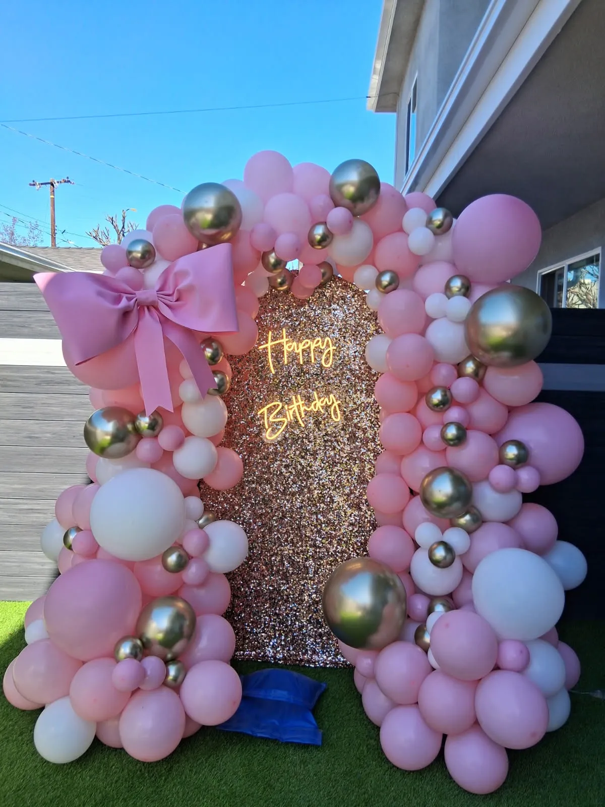 White, pink, and gold happy birthday balloon decoration with bow